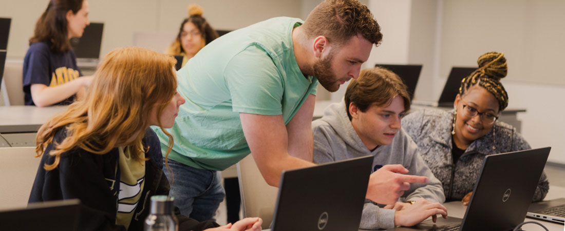 Student working with a professor in a class at The University of Akron.