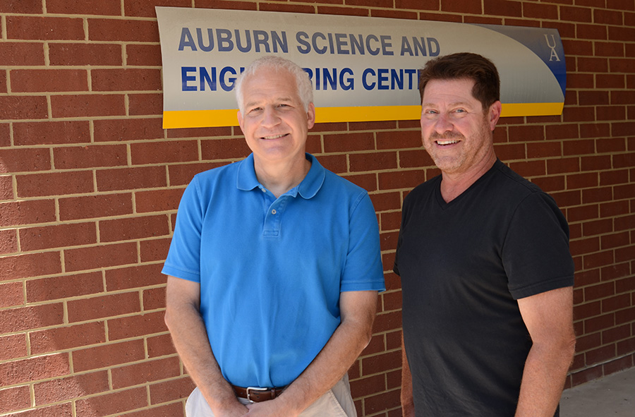 Two men on UA campus on a sunny day.