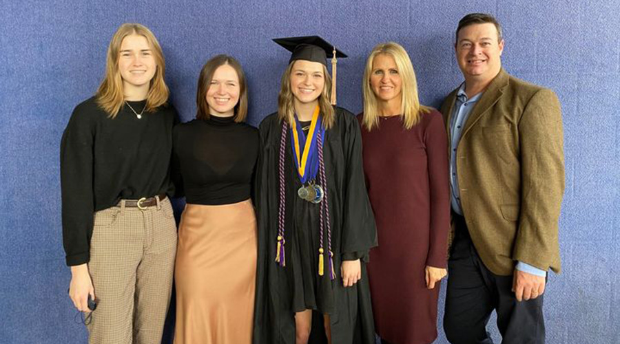 Muntin family posing against blue background. loading=