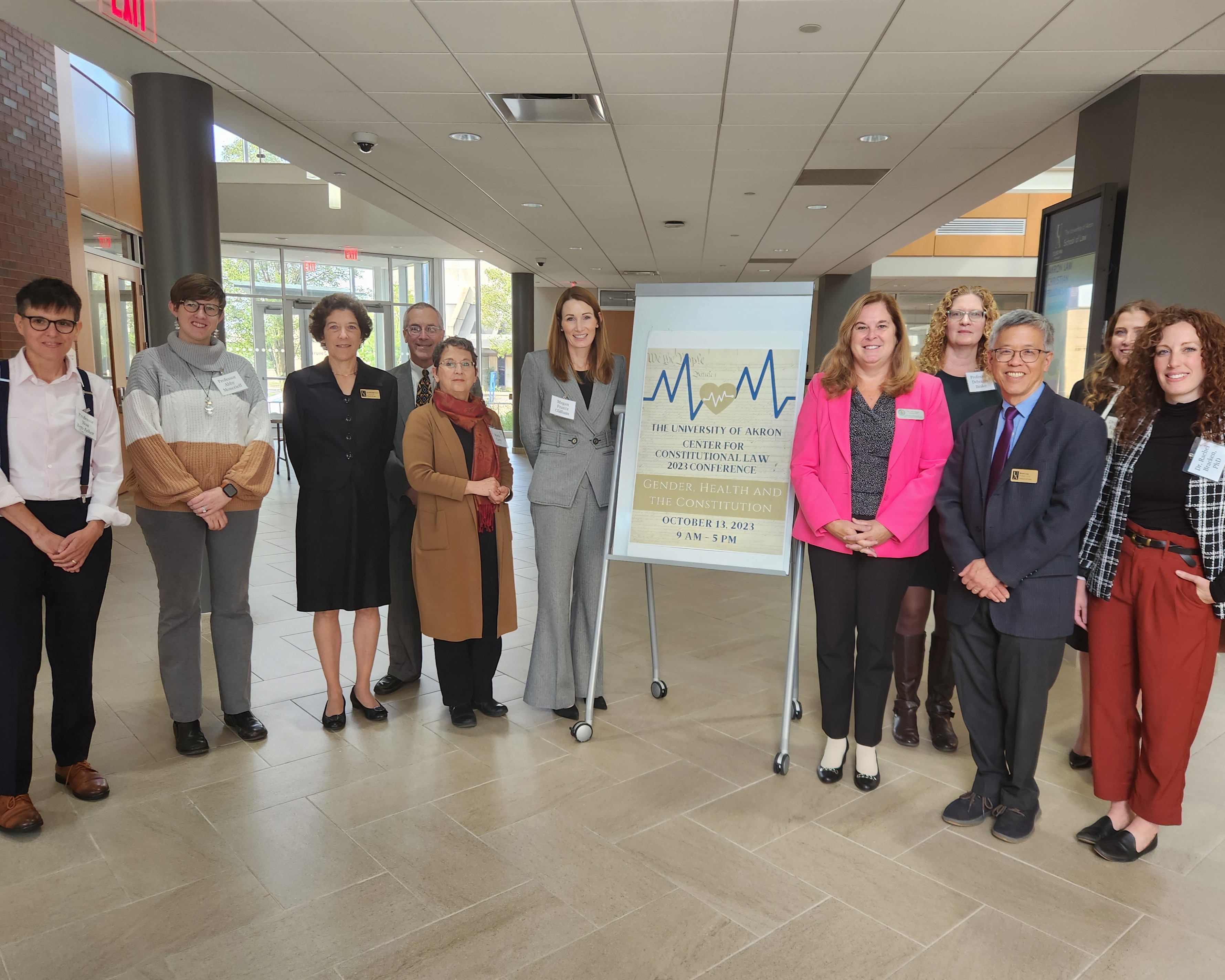 A number of conference panelists and moderators posed outside the courtroom during a break.